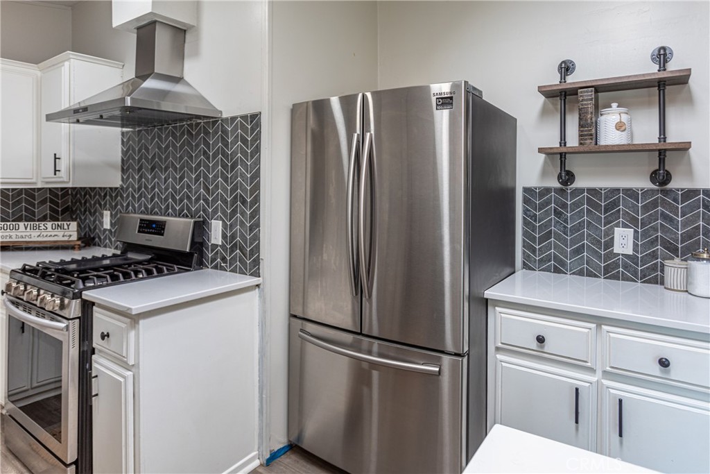 27568 Ruby Lane Castaic, CA 91384 - Photo 14 of 34 a kitchen with stainless steel appliances a refrigerator stove and microwave