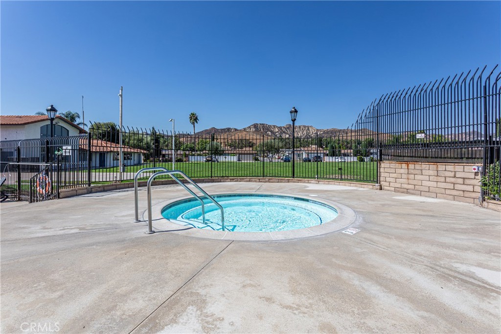 27568 Ruby Lane Castaic, CA 91384 - Photo 30 of 34 a view of a swimming pool with a slide and a bench