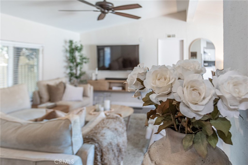 27568 Ruby Lane Castaic, CA 91384 - Photo 7 of 34 a living room with furniture floor to ceiling window kitchen view and a flat screen tv