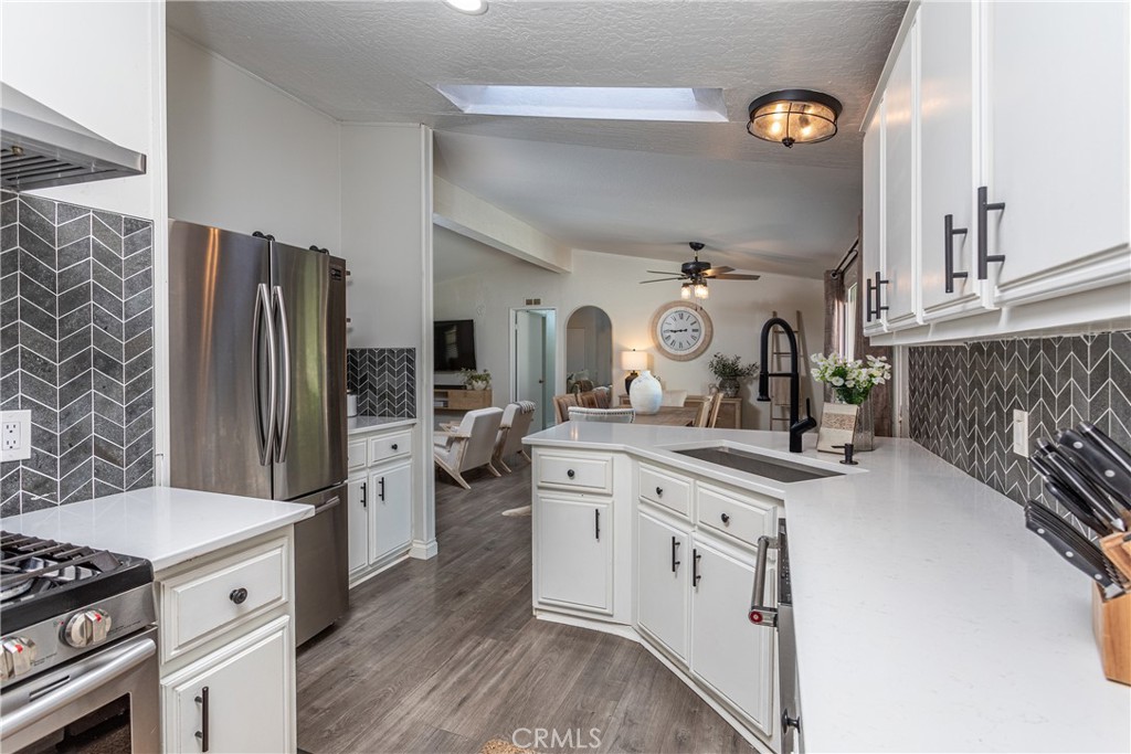 27568 Ruby Lane Castaic, CA 91384 - Photo 10 of 34 a kitchen with stainless steel appliances a sink stove and refrigerator
