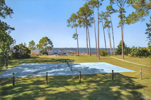 a view of a swimming pool with a patio and a yard