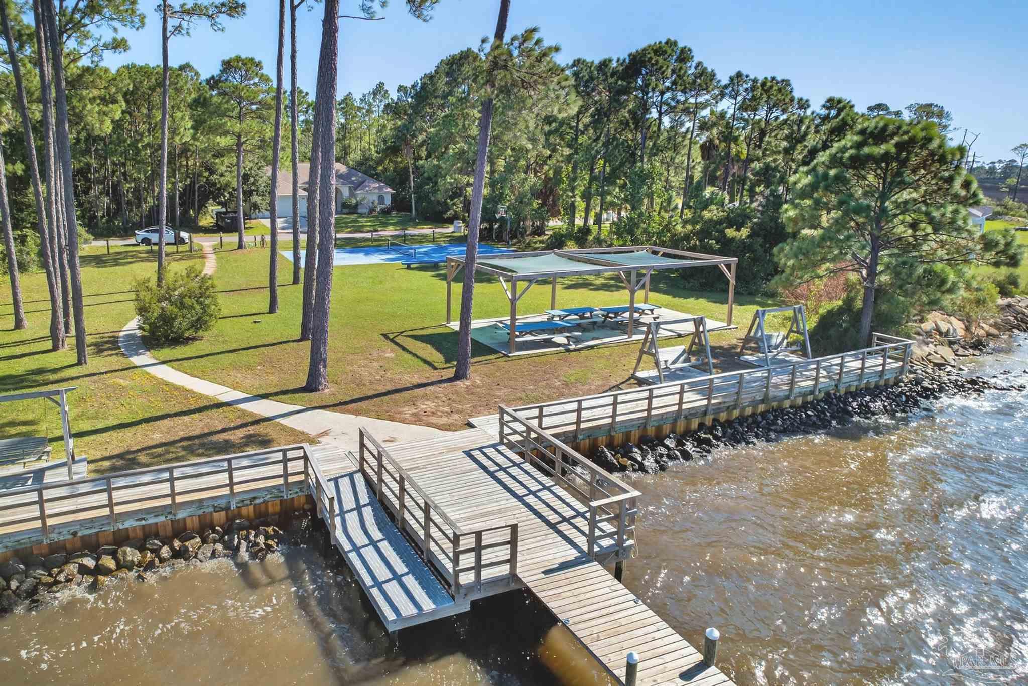 5931 Red Cedar Street Pensacola, FL 32507 - Photo 6 of 15 a view of a swimming pool with a patio and a yard