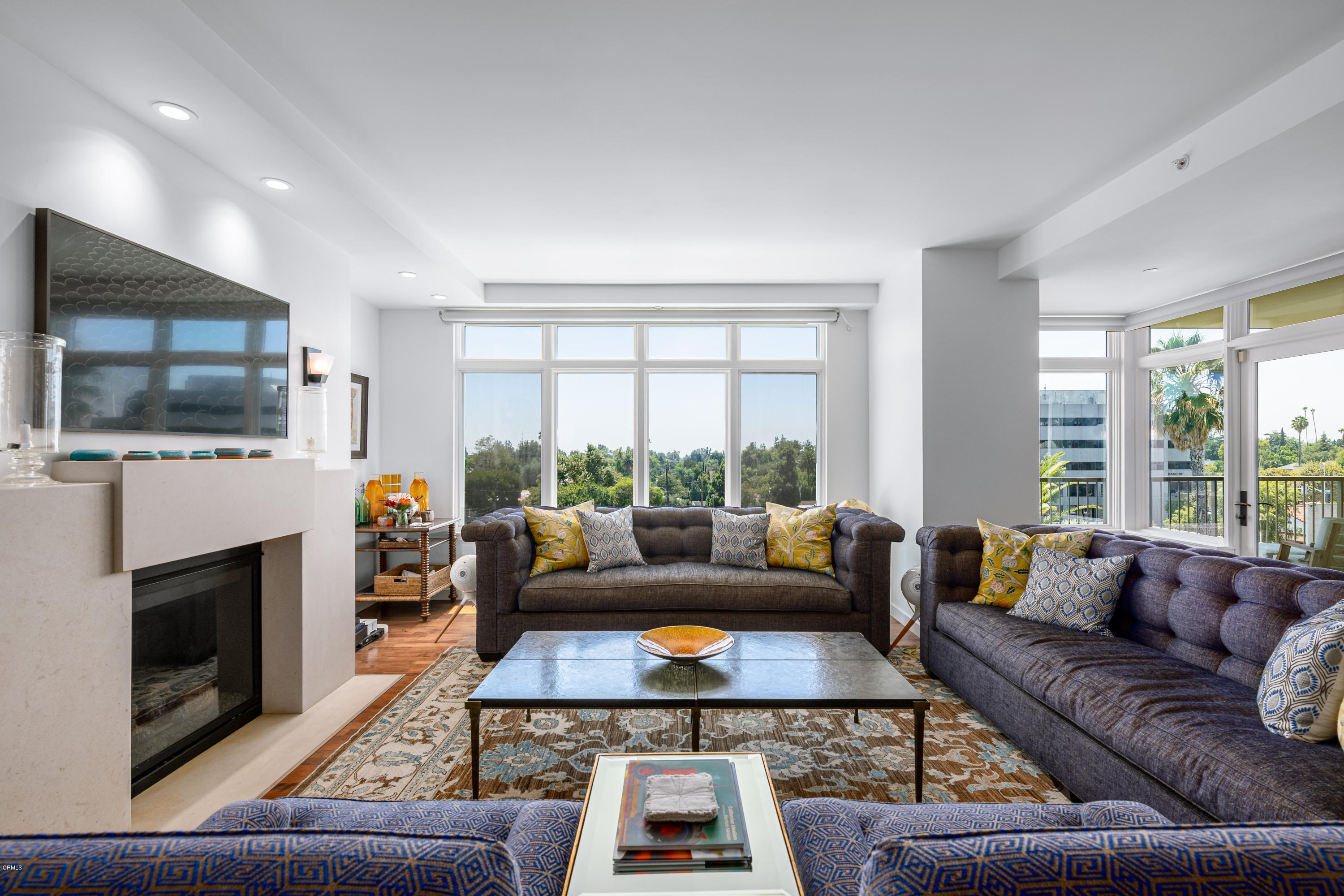 920 Granite Drive, Unit 509 Pasadena, CA 91101 - Photo 5 of 26 a living room with furniture a flat screen tv and a fireplace