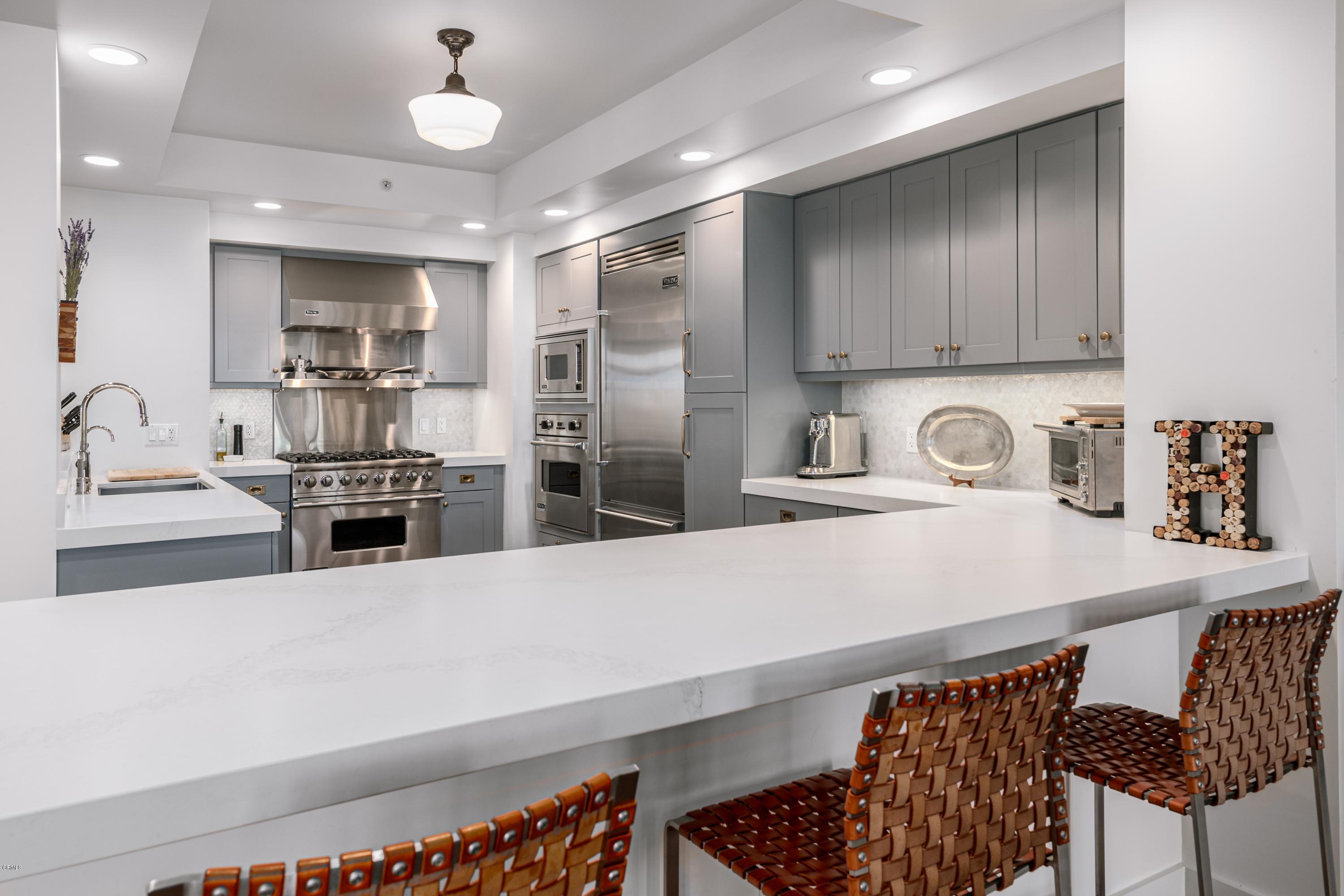 920 Granite Drive, Unit 509 Pasadena, CA 91101 - Photo 8 of 26 a kitchen with stainless steel appliances a sink and a refrigerator