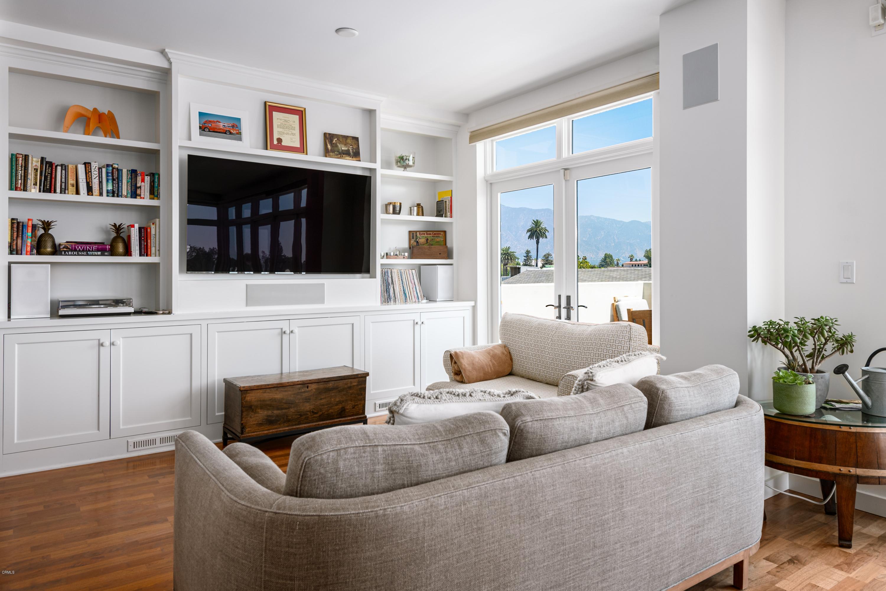 920 Granite Drive, Unit 509 Pasadena, CA 91101 - Photo 10 of 26 a living room with furniture a bookshelf and a window