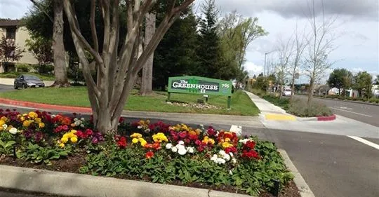 a sign that is in front of flowers