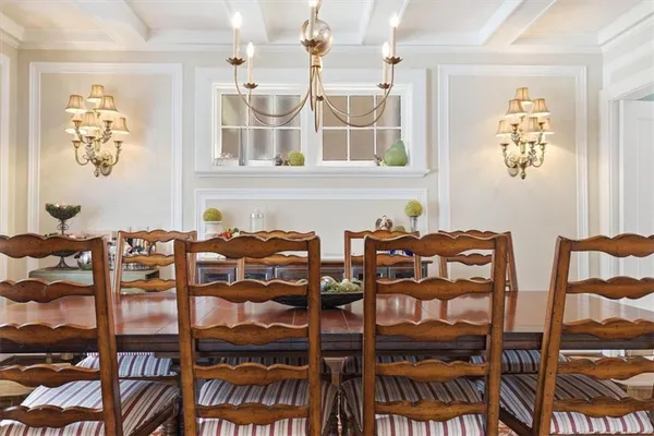 a view of a dining room with furniture and chandelier