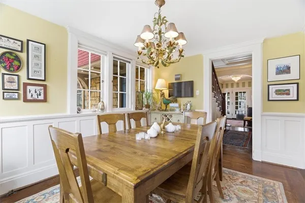 a view of a dining room with furniture wooden floor and chandelier