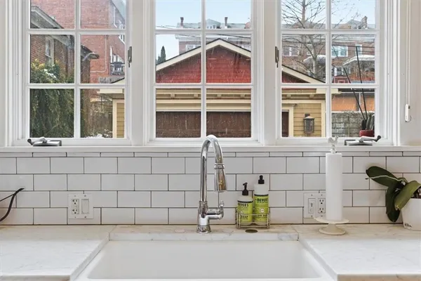 a kitchen with stainless steel appliances granite countertop a sink and a refrigerator