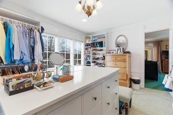 a bedroom with a bed couch and a window