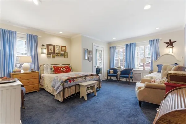 a bedroom with furniture and a wooden floor