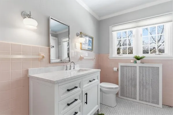 a spacious bathroom with a double vanity sink a toilet a shower and a mirror