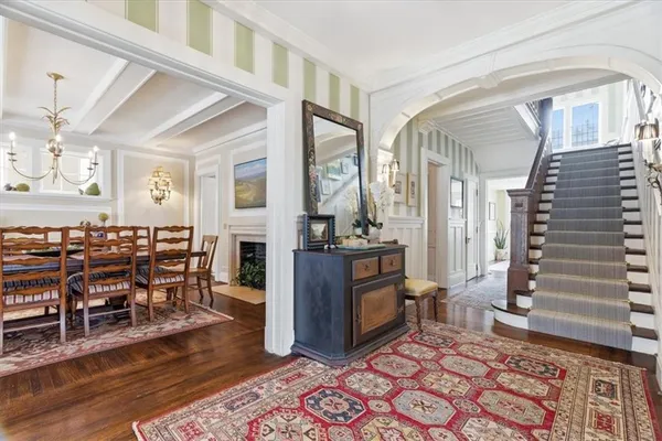 a living room with furniture a fireplace and wooden floor