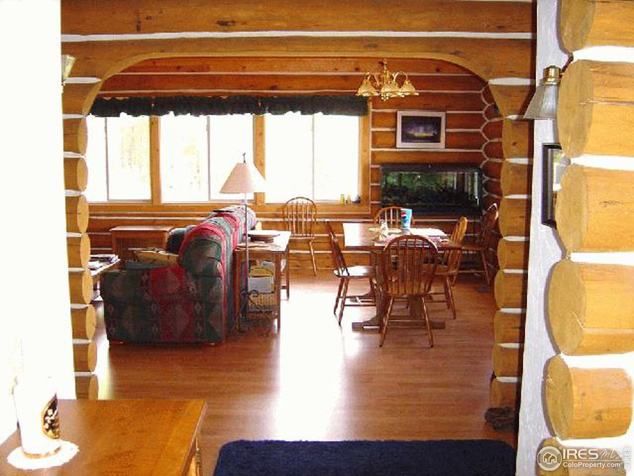 15855 Rist Canyon Road Bellvue, CO 80512 - Photo 5 of 12 view of living room with furniture and floor to ceiling window