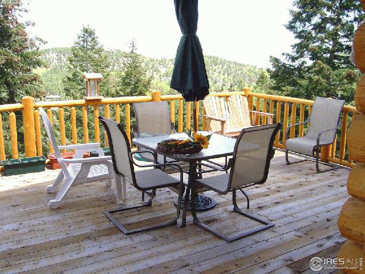 15855 Rist Canyon Road Bellvue, CO 80512 - Photo 9 of 12 a view of deck with table and chairs and wooden floor