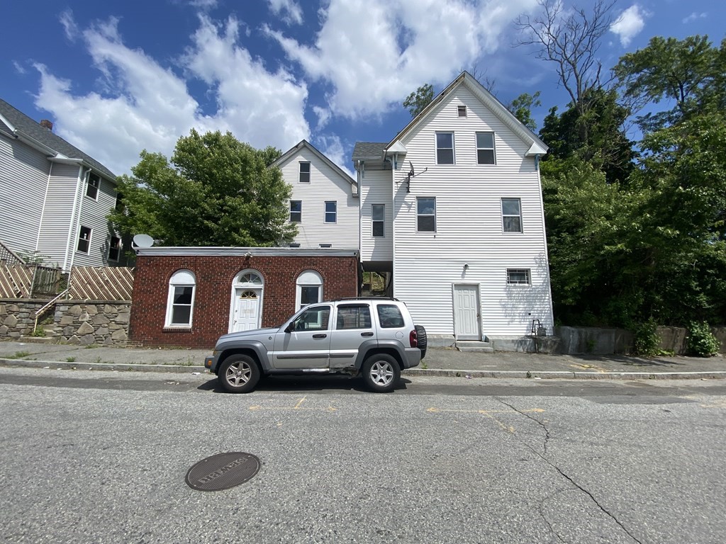 a front view of a house with parking space