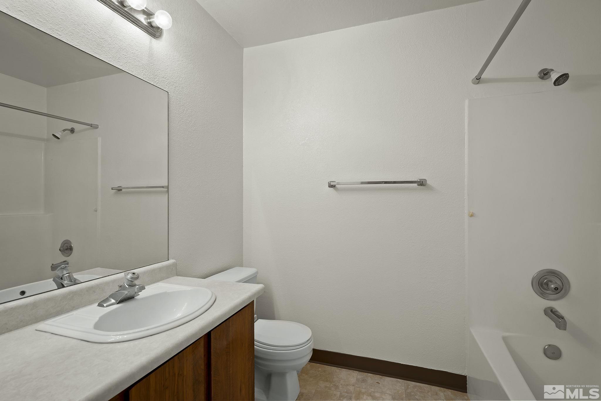 4893 Reggie Road Reno, NV 89502 - Photo 15 of 27 a bathroom with a sink toilet and vanity