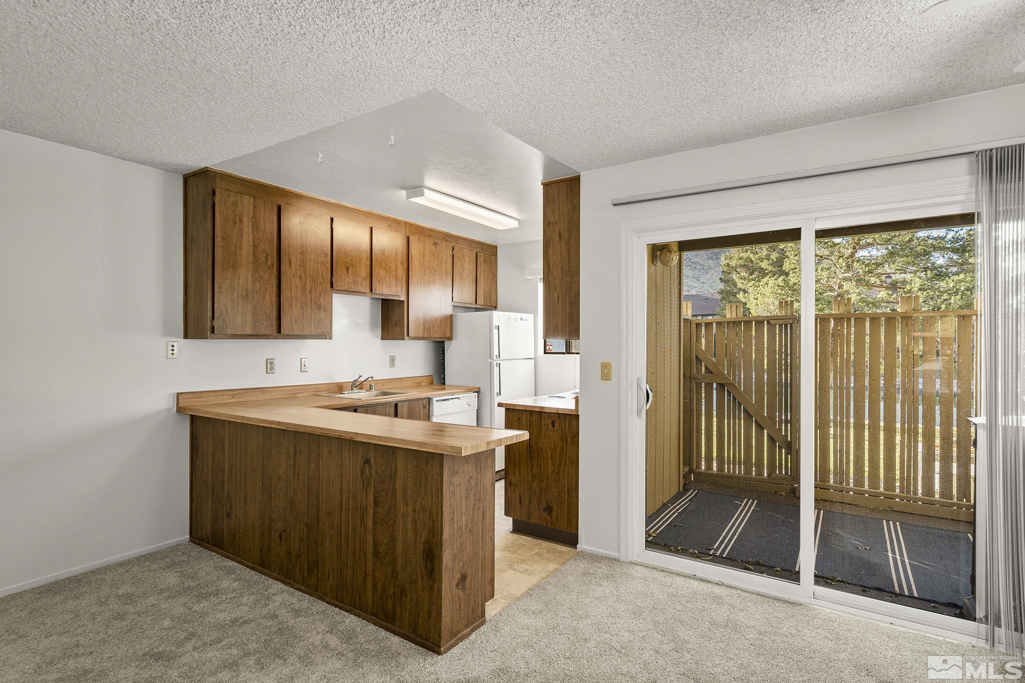 4893 Reggie Road Reno, NV 89502 - Photo 6 of 27 a kitchen with a stove and a refrigerator