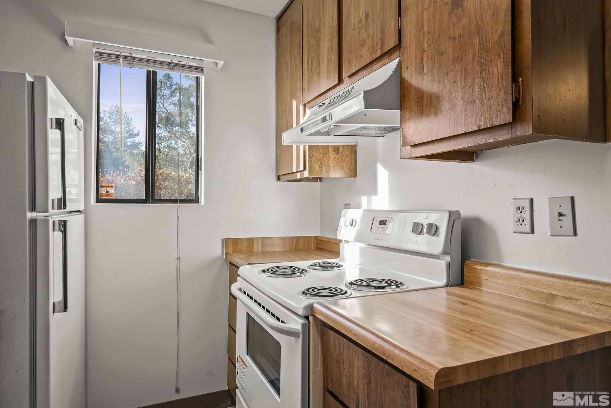 4893 Reggie Road Reno, NV 89502 - Photo 9 of 27 a kitchen with a stove and a refrigerator