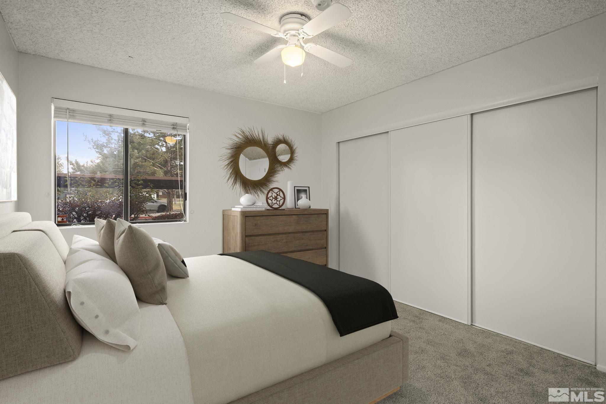 4893 Reggie Road Reno, NV 89502 - Photo 10 of 27 a bedroom with a bed and a large window