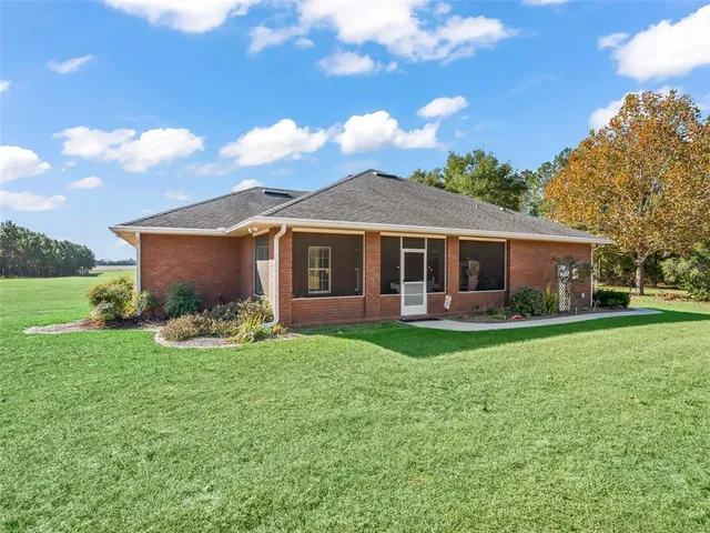 an aerial view of a residential houses with outdoor space and street view