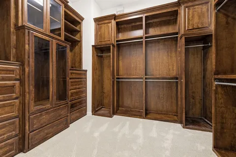 a view of walk in closet with wooden walls