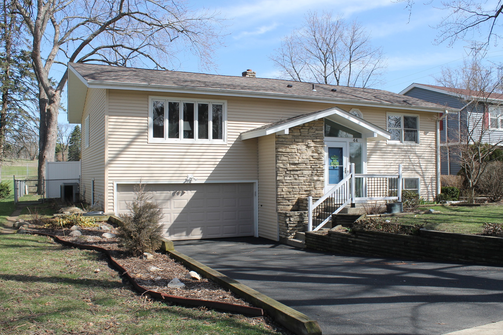 44 Sunset Drive Cary, IL 60013 - Photo 4 of 4 a front view of a house with garden