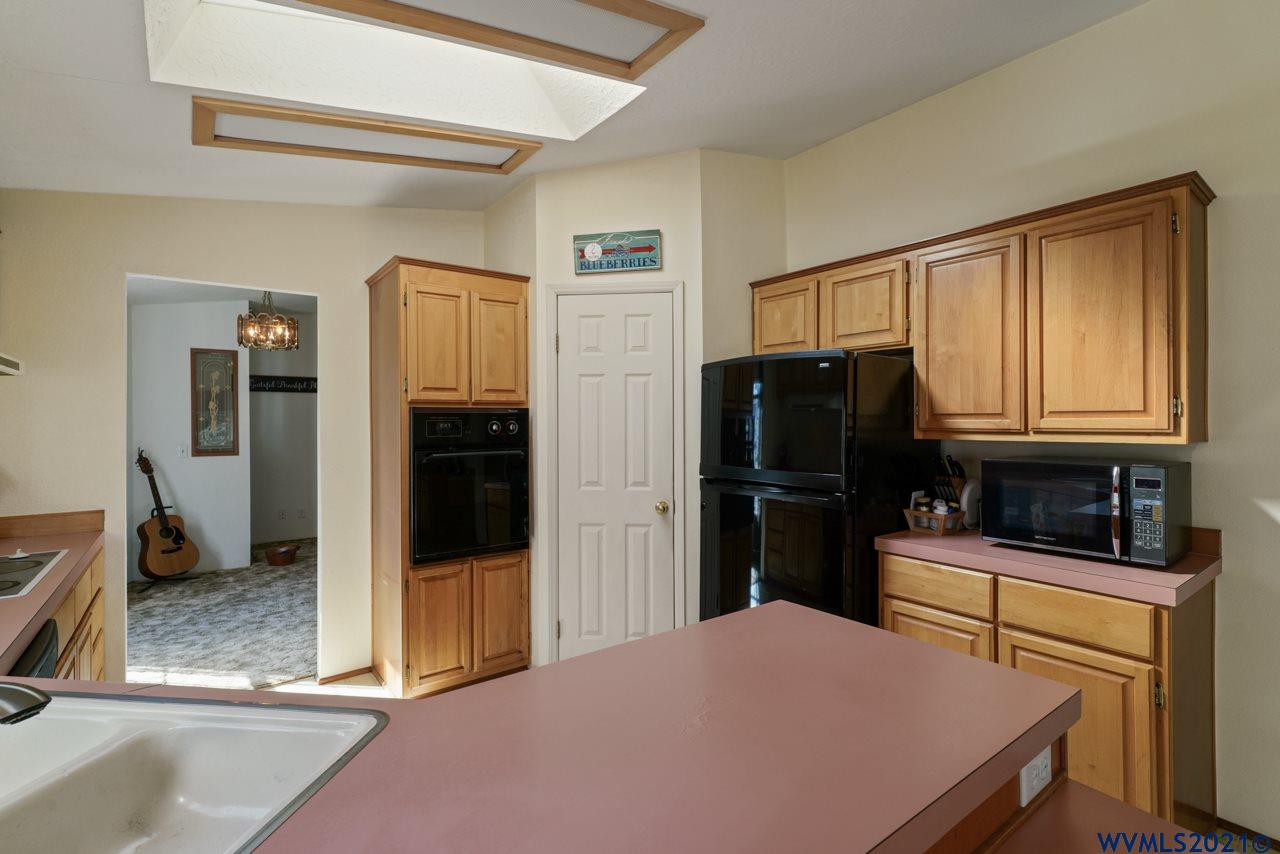153 Hylo Road Southeast Salem, OR 97306 - Photo 18 of 41 a kitchen with a refrigerator stove and cabinets