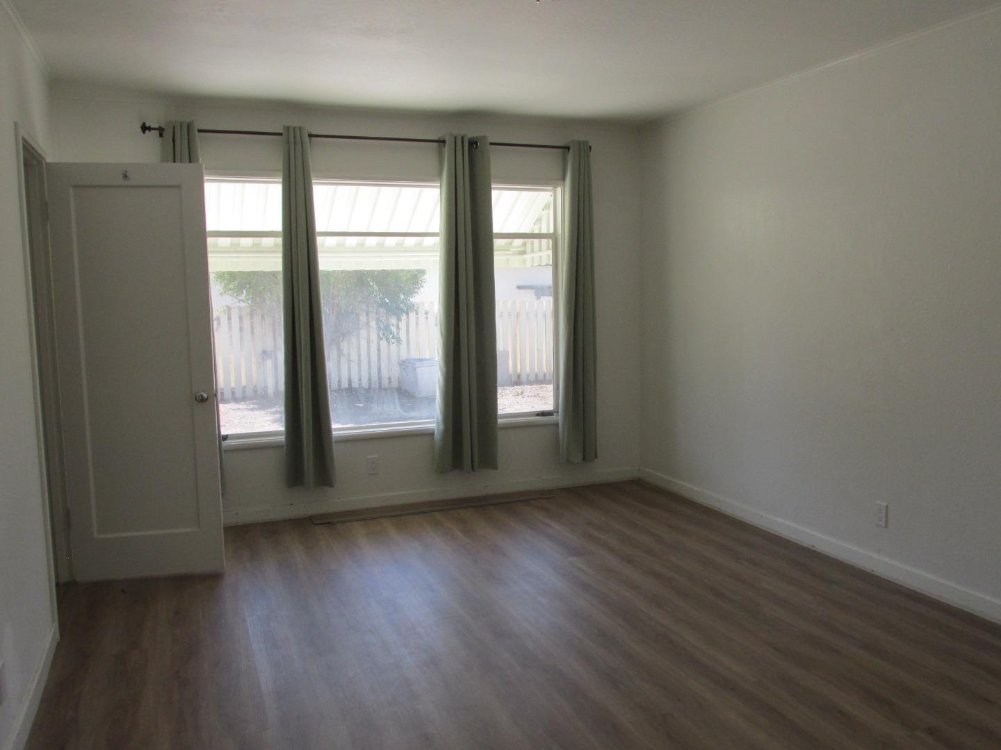1610 Cienega Road Hollister, CA 95023 - Photo 14 of 35 an empty room with wooden floor and windows
