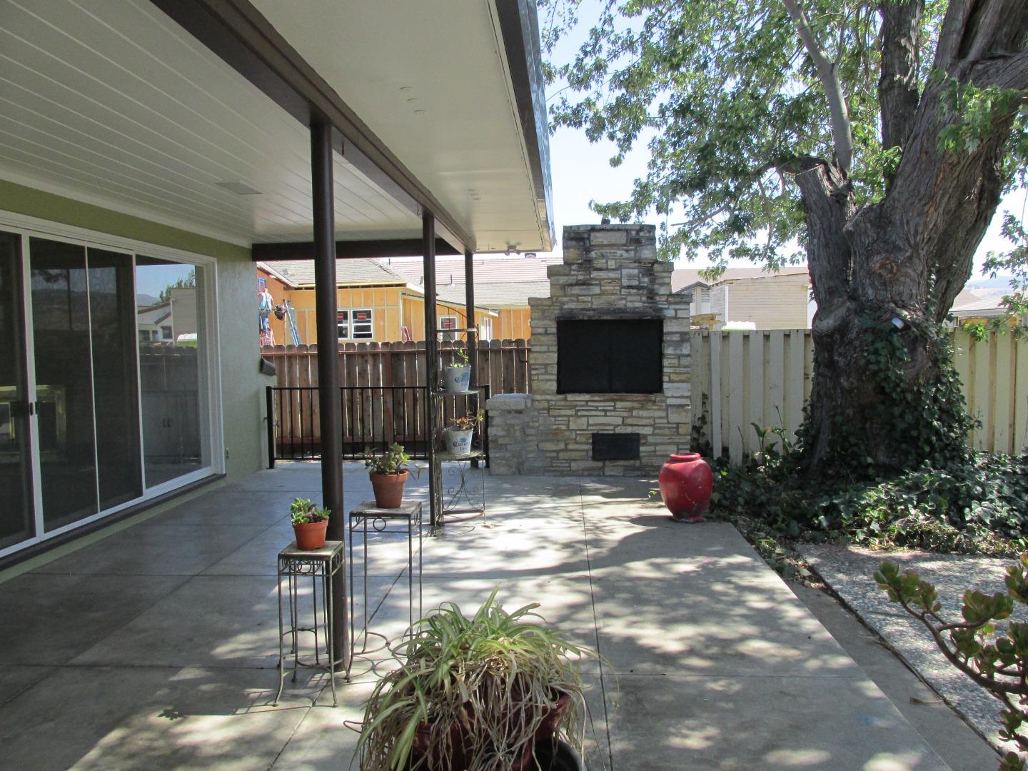 1610 Cienega Road Hollister, CA 95023 - Photo 22 of 35 a view of a patio with table and chairs potted plants and large tree
