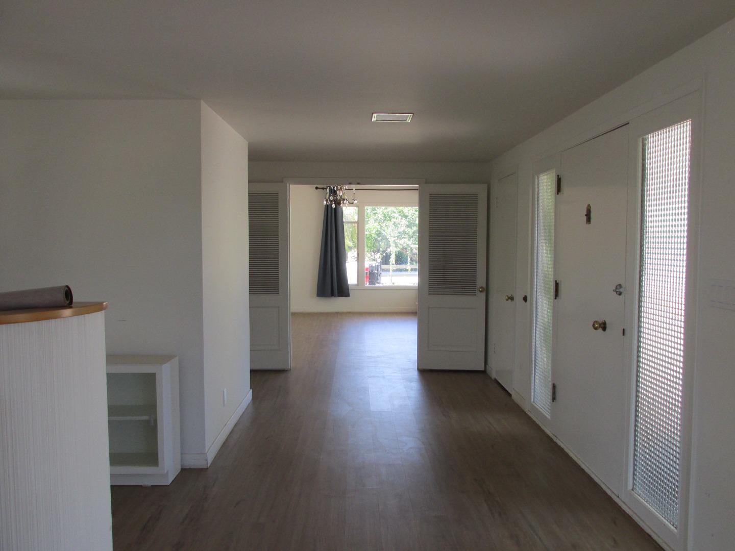 1610 Cienega Road Hollister, CA 95023 - Photo 4 of 35 a view of a hallway with wooden floor and windows
