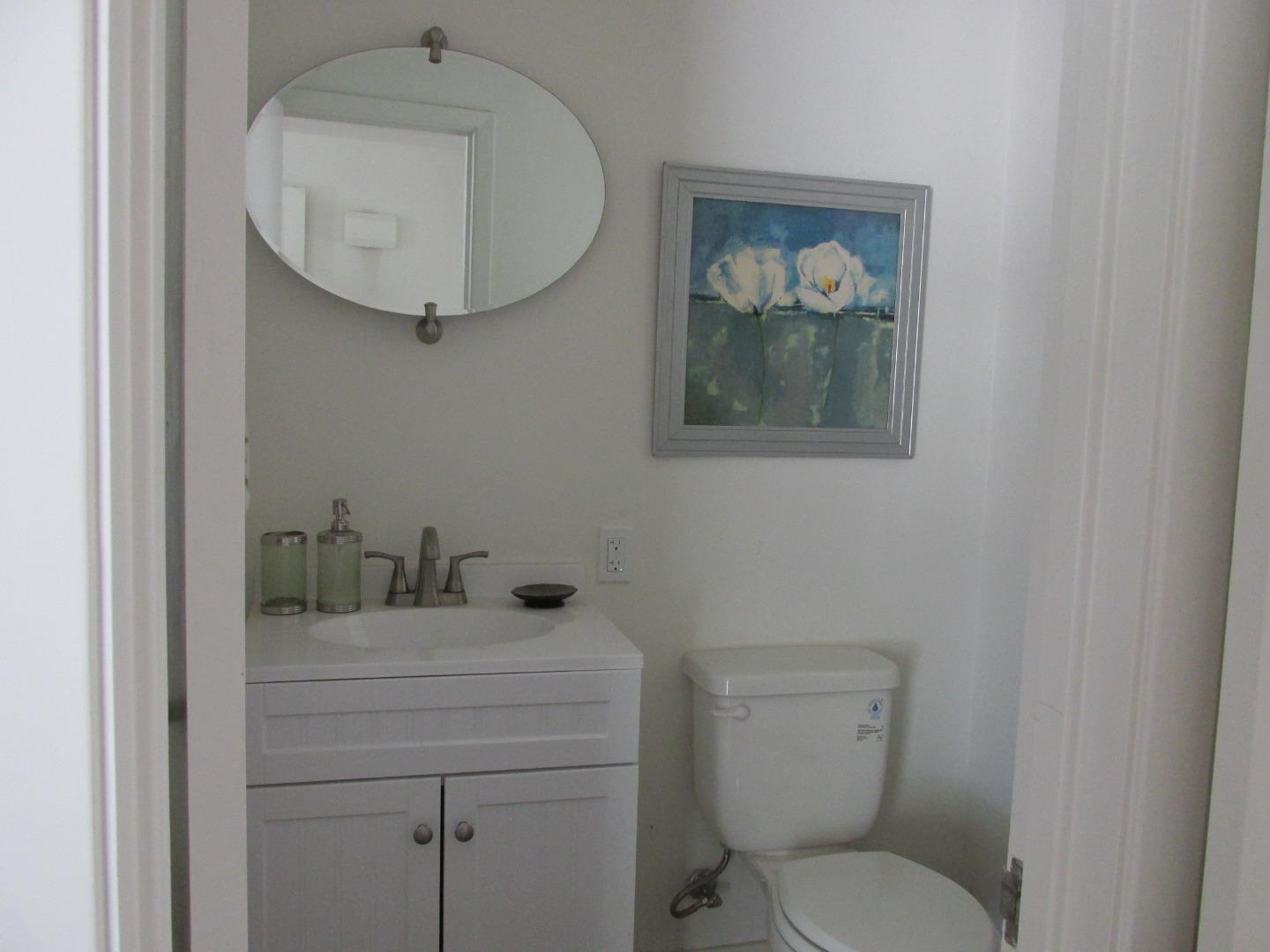1610 Cienega Road Hollister, CA 95023 - Photo 5 of 35 a bathroom with a toilet a sink and mirror
