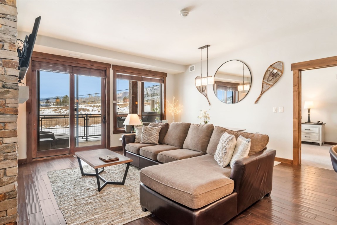 1175 Bangtail Way, Unit 4120 Steamboat Springs, CO 80487 - Photo 2 of 43 a living room with furniture and a large window