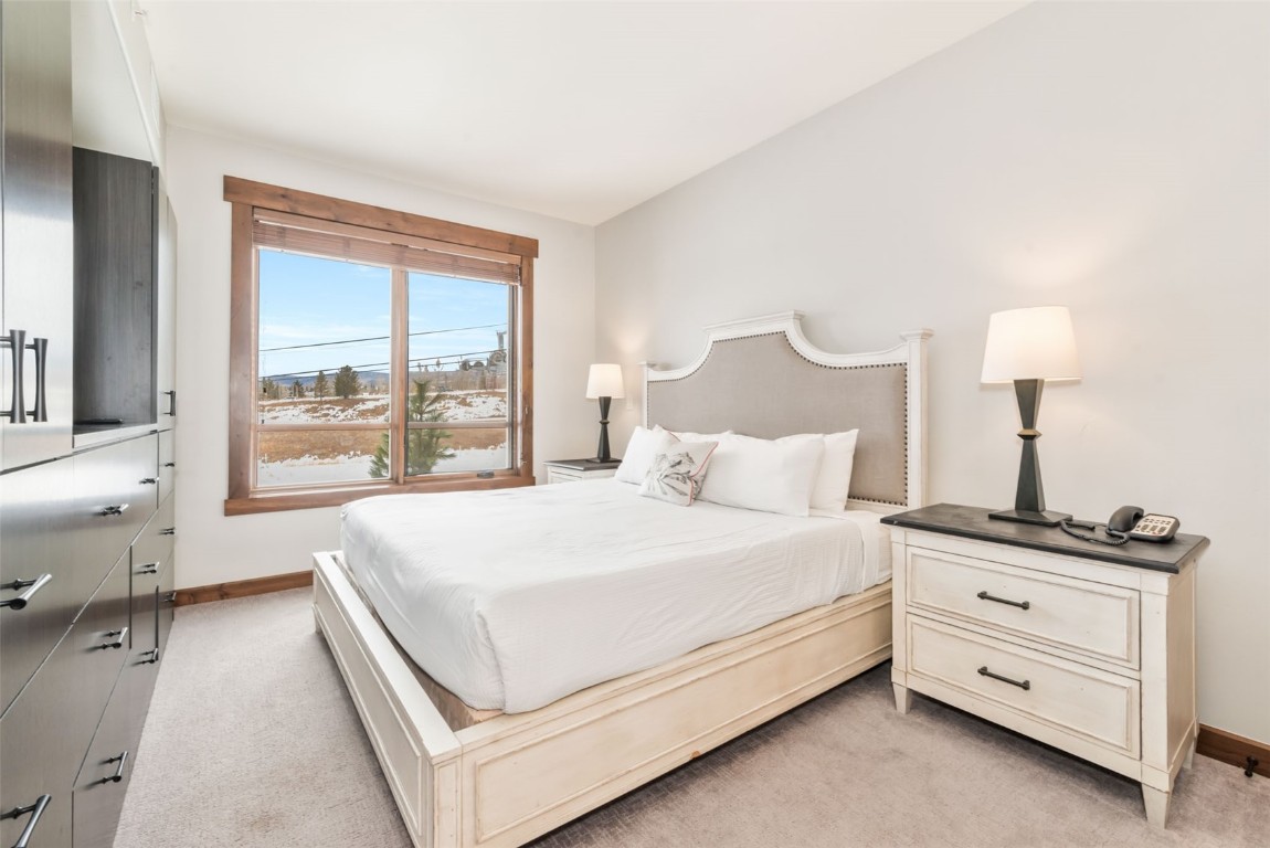 1175 Bangtail Way, Unit 4120 Steamboat Springs, CO 80487 - Photo 22 of 43 a bed room with a bed and a night stand