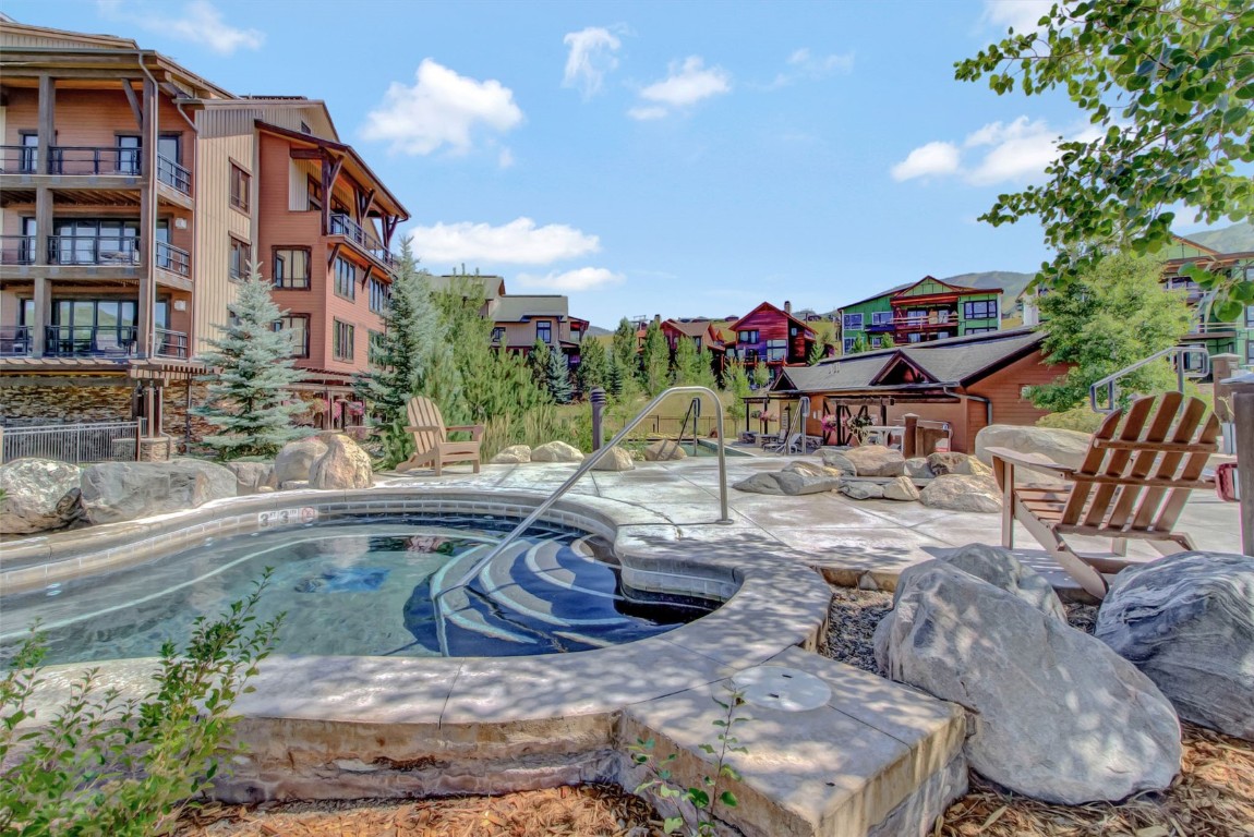 1175 Bangtail Way, Unit 4120 Steamboat Springs, CO 80487 - Photo 37 of 43 a swimming pool with outdoor seating and yard
