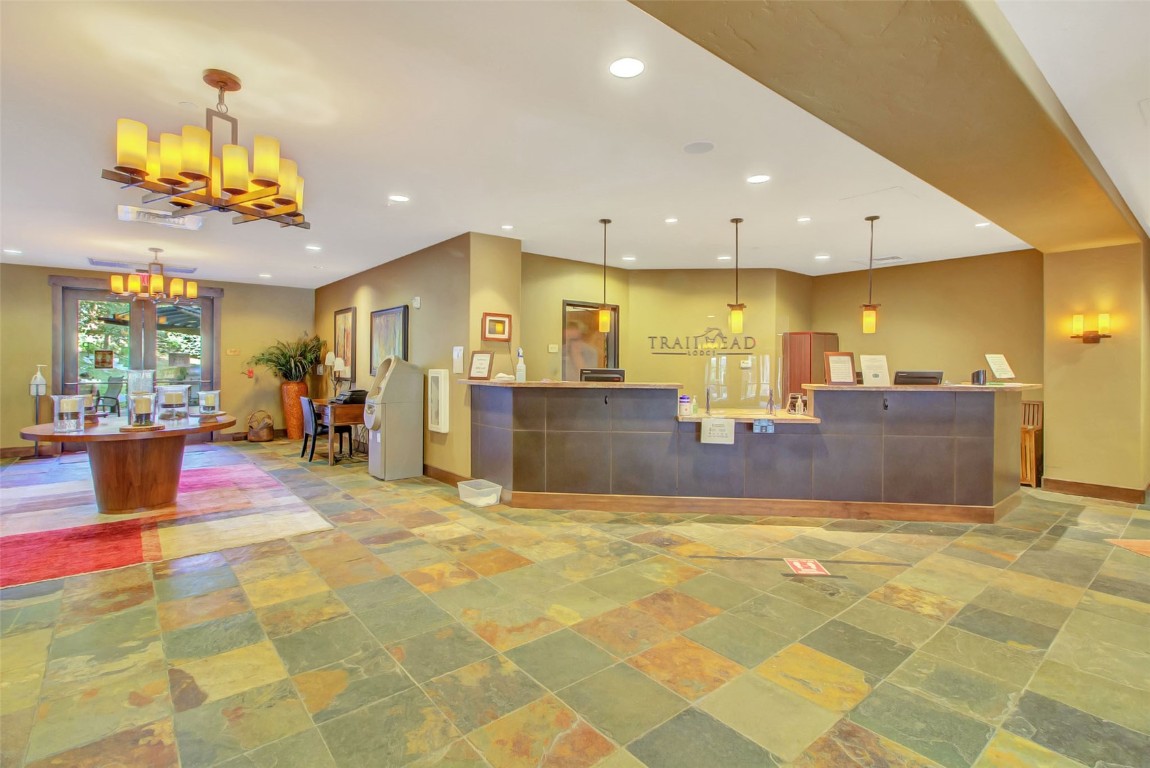 1175 Bangtail Way, Unit 4120 Steamboat Springs, CO 80487 - Photo 39 of 43 a view of a kitchen with a dining table and chandelier