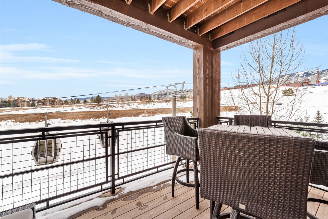 1175 Bangtail Way, Unit 4120 Steamboat Springs, CO 80487 - Photo 8 of 43 a view of a balcony with chair and wooden floor