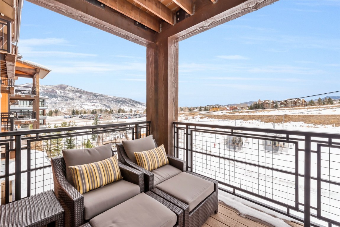 1175 Bangtail Way, Unit 4120 Steamboat Springs, CO 80487 - Photo 9 of 43 a view of a balcony with wooden floor