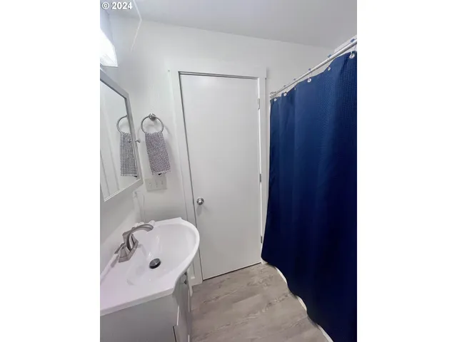 a bathroom with a granite countertop sink and mirror