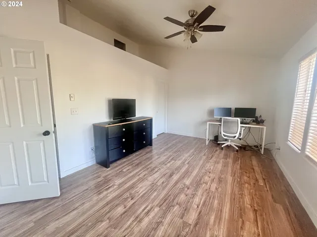 a living room with a furniture and a flat screen tv