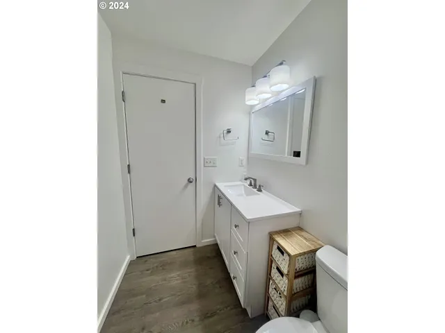 a bathroom with a sink shower and a mirror