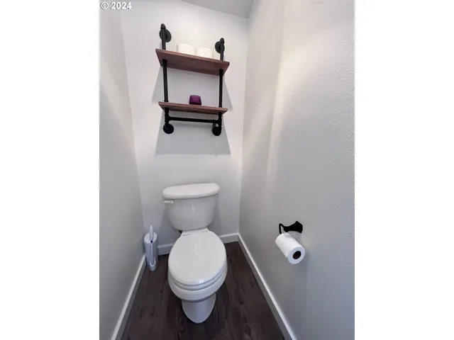 a white toilet sitting next to a bathroom sink