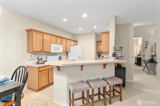 a kitchen with a sink chairs and cabinets
