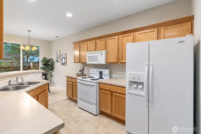 a kitchen with a sink a stove a refrigerator and a refrigerator