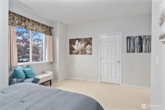 a bedroom with a large bed and a window