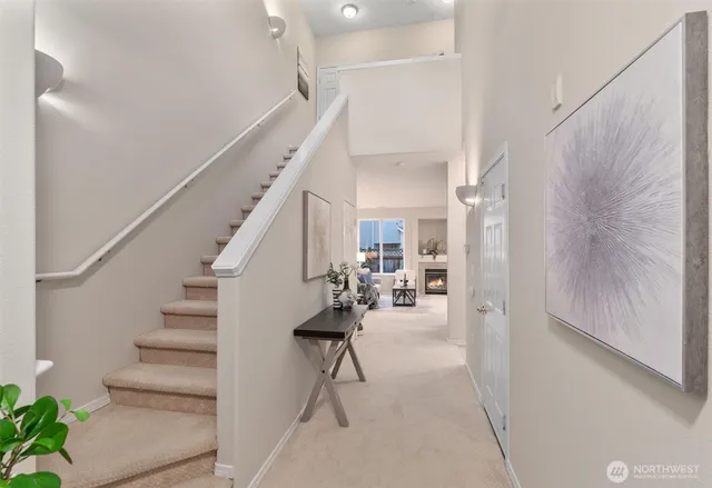 a view of entryway and hall with wooden floor