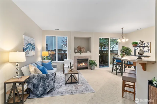 a living room with furniture a fireplace and a table