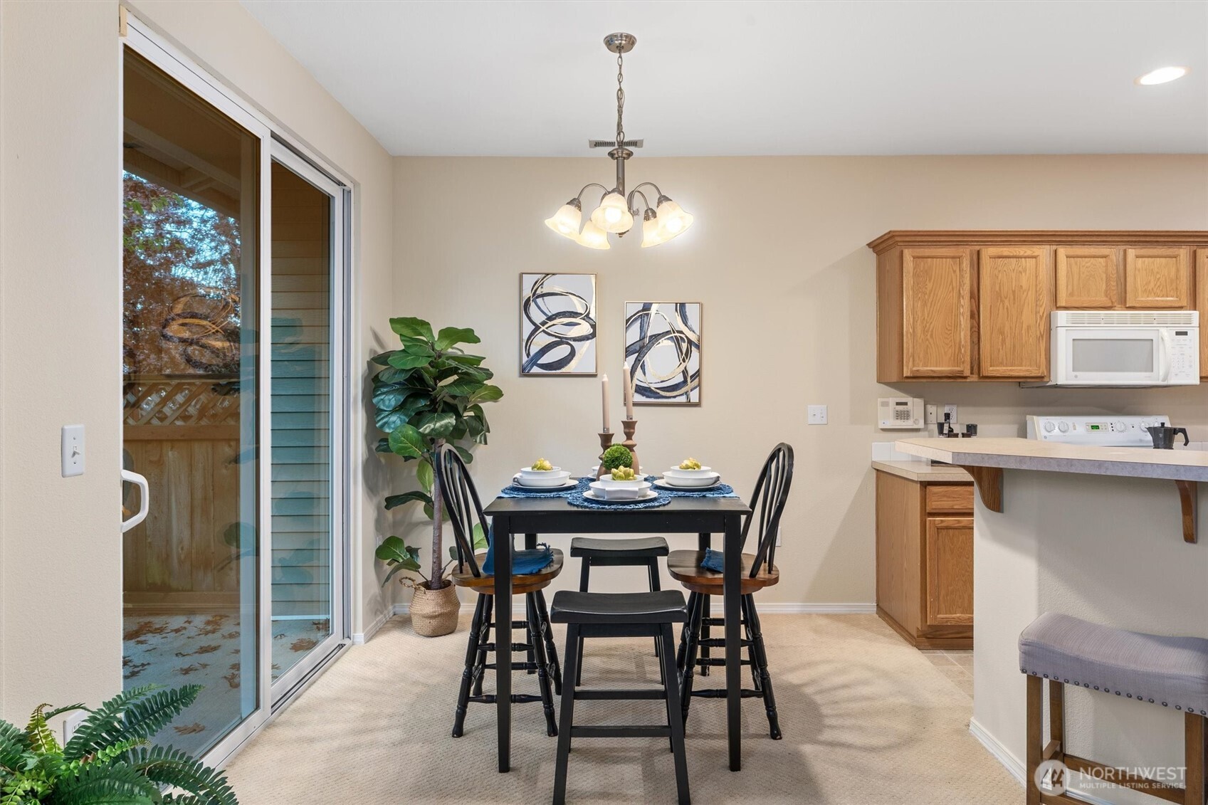 3030 Southeast 12th Street, Unit 1077 Renton, WA 98058 - Photo 10 of 36 a view of a dining room with furniture and chandelier