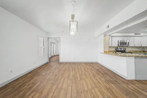 a view of kitchen with granite countertop cabinets and wooden floor