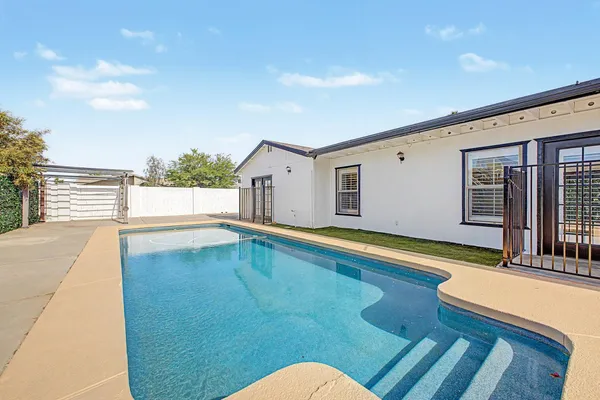 a view of a swimming pool with an outdoor seating